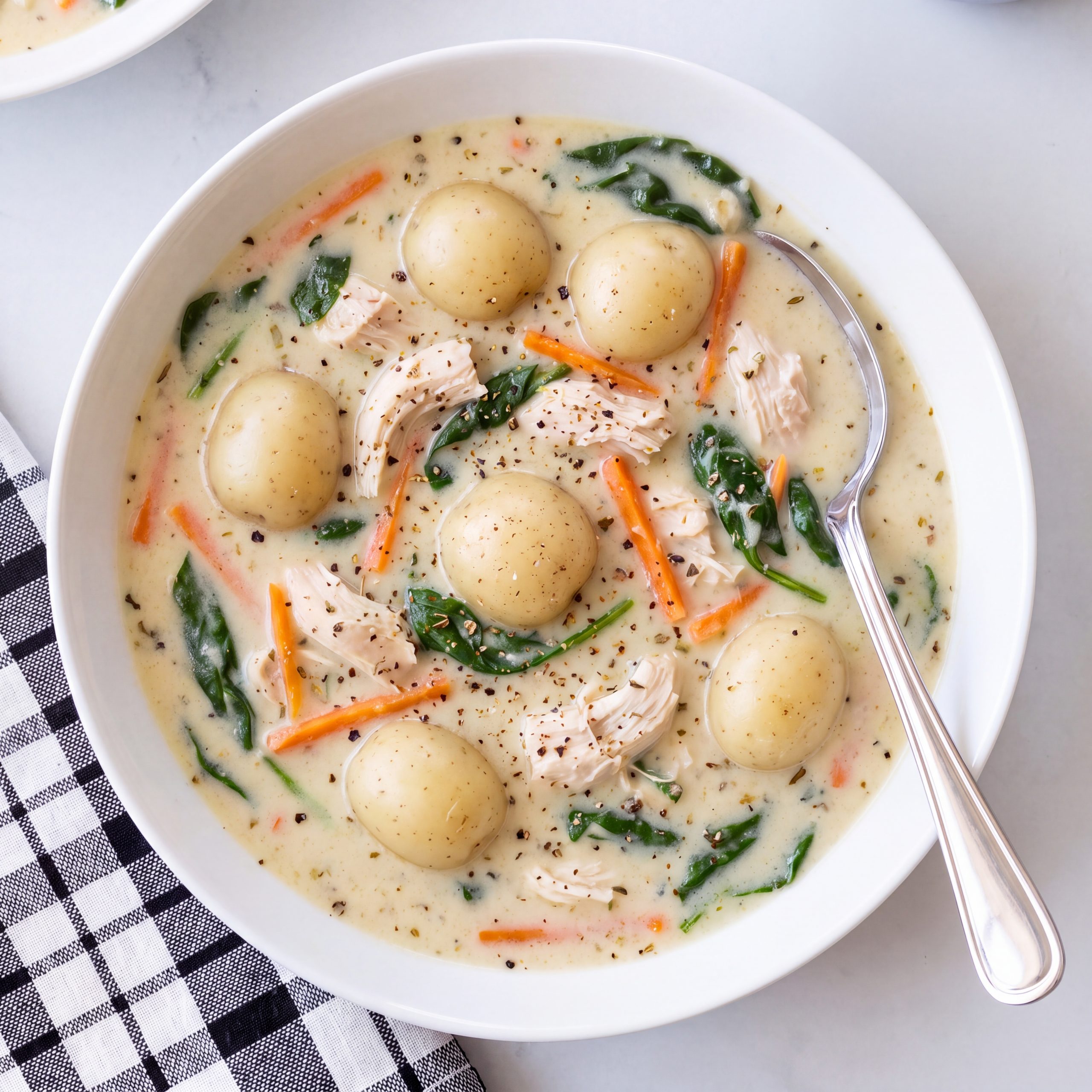 Bowl of creamy chicken gnocchi soup olive garden copycat with spinach and parmesan